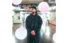 Download Foto: Eine Person steht in dunkler Kleidung in einer hell erleuchteten U-Bahn-Station, umgeben von großen, unscharfen, rosa Lichtern.